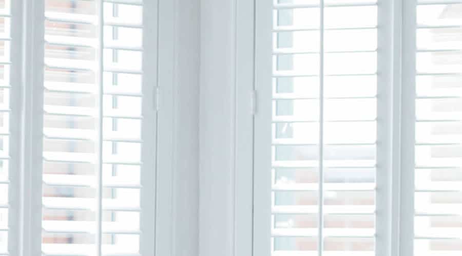 White interior shutter blinds in living room White interior shutter blinds in living room